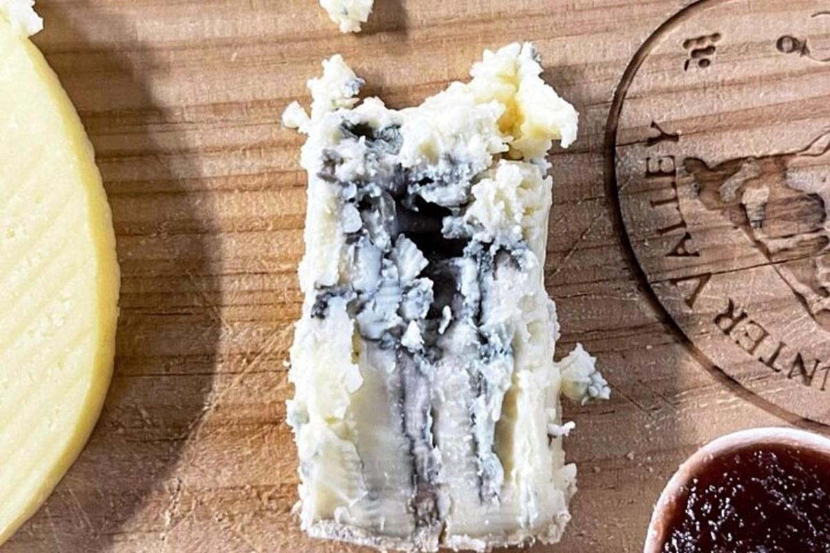 a piece of cheese on top of a cutting board