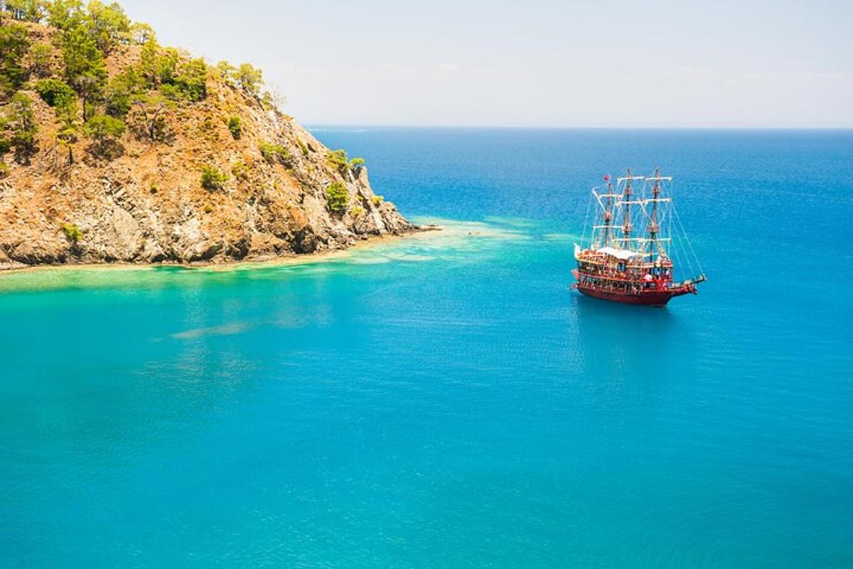 a boat in the water next to an island