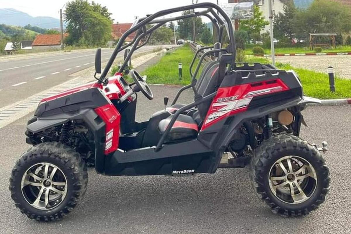 a black and red atv parked on the side of a road