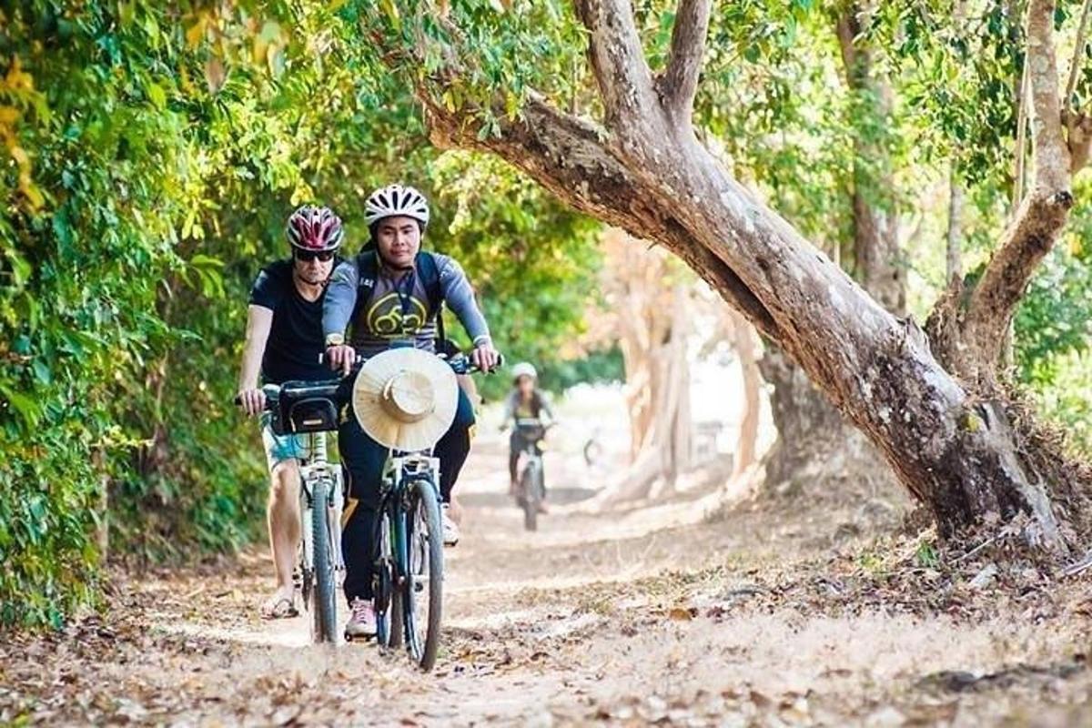 un home i una dona anant en bicicleta per un camí de terra