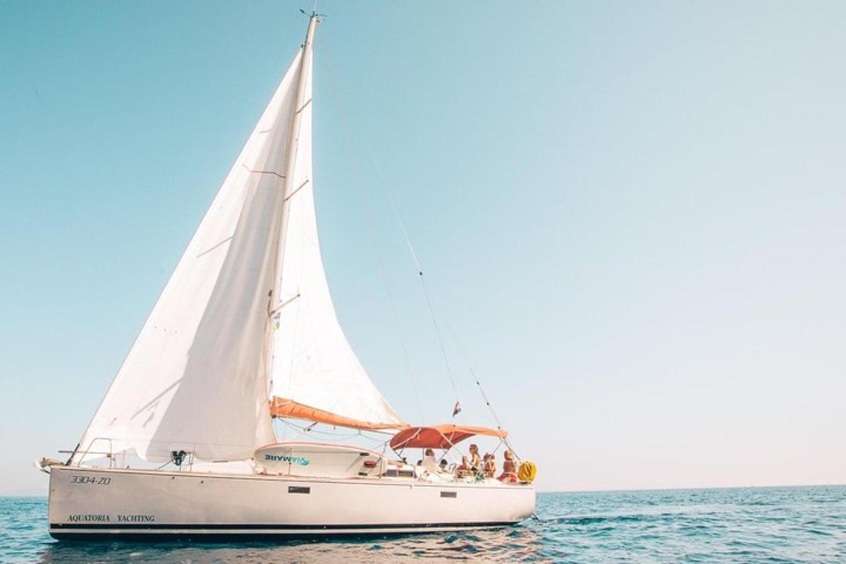 ein Segelboot im Meer mit einer Gruppe von Menschen darauf