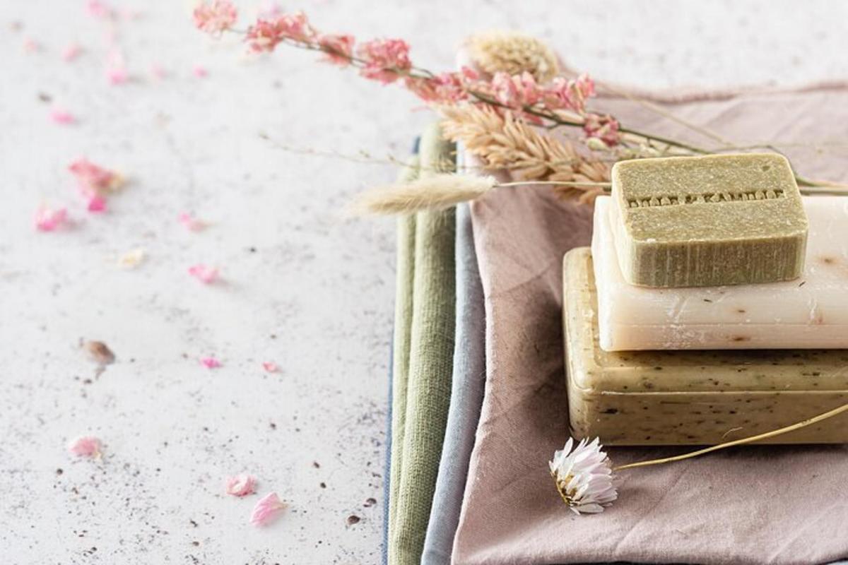 two blocks of soap sitting on a table with flowers