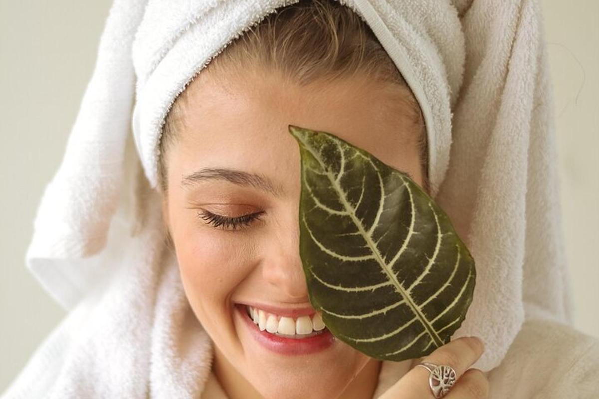 a woman in a towel with a leaf on her head