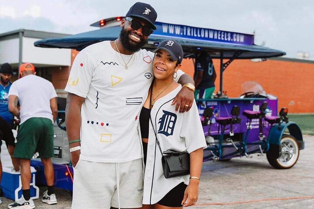 a man and a woman standing next to a cart