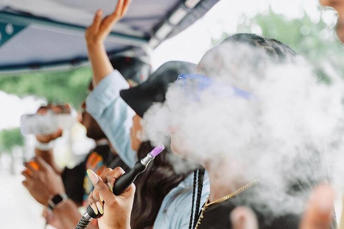 a woman smoking acigarette in a crowd of people