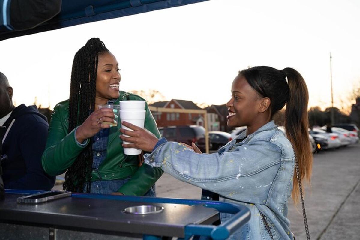 two women sitting at a table drinking coffee
