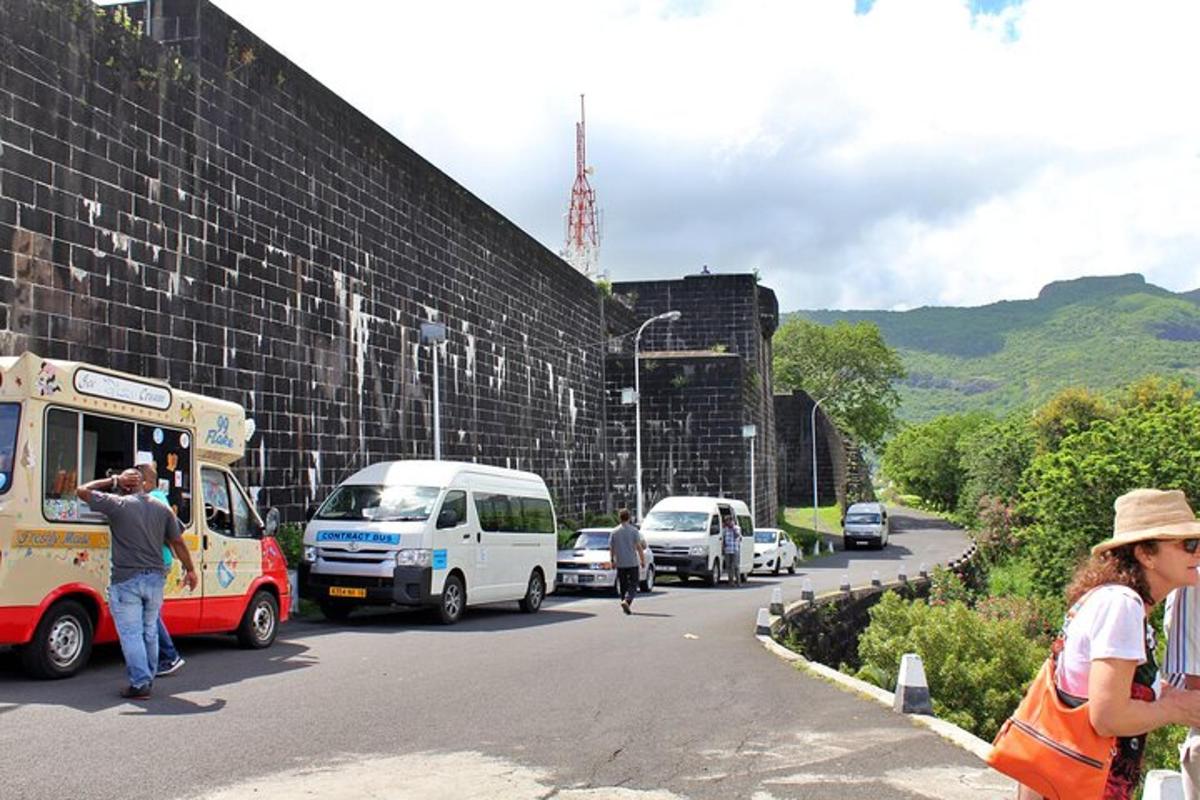 eine Gruppe von Autos, die neben einer Mauer geparkt sind