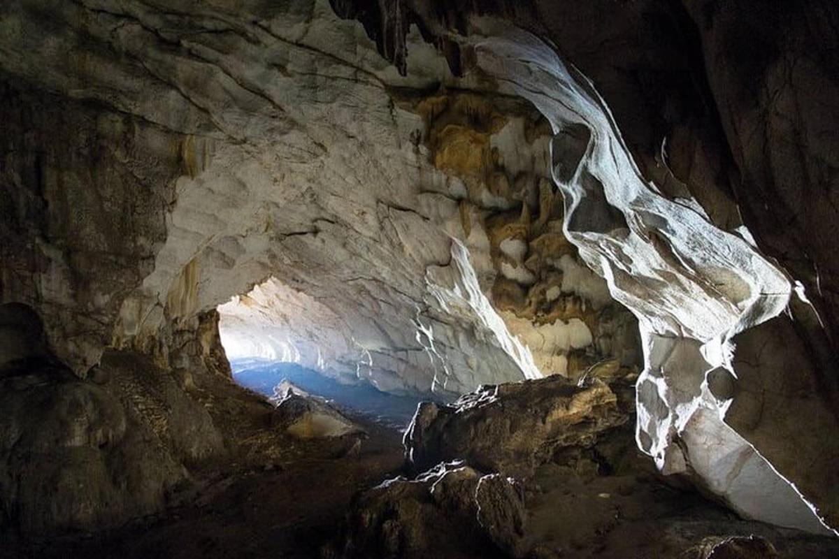 μια σπηλιά με είσοδο σπηλαίου με νερό μέσα