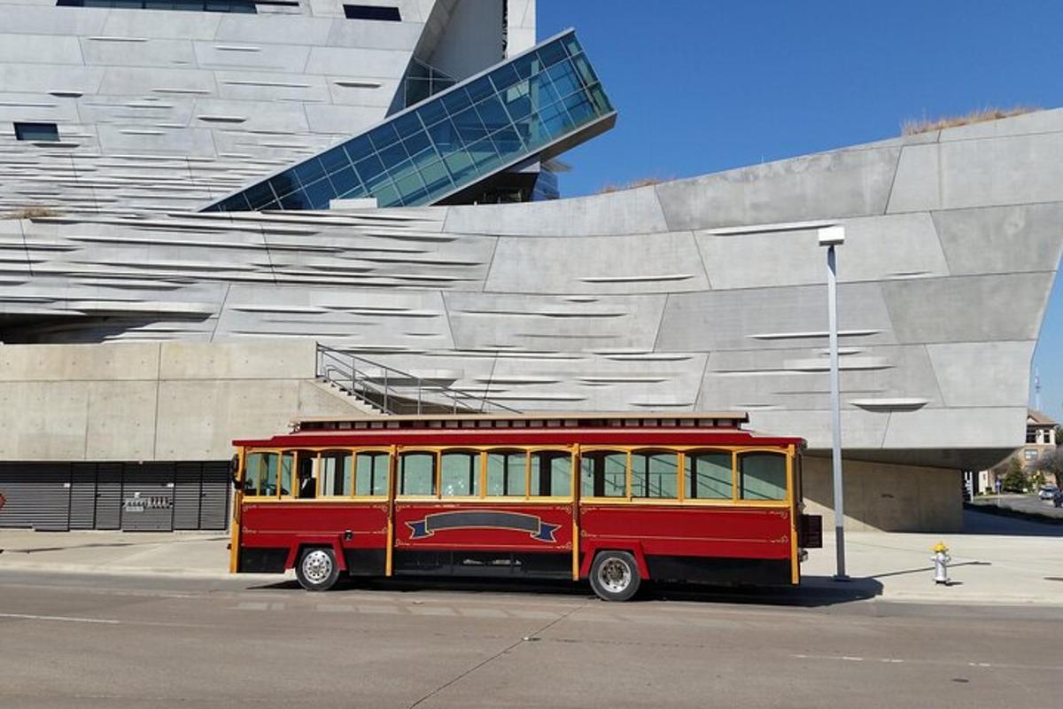 a red and yellow bus parked in front of a building