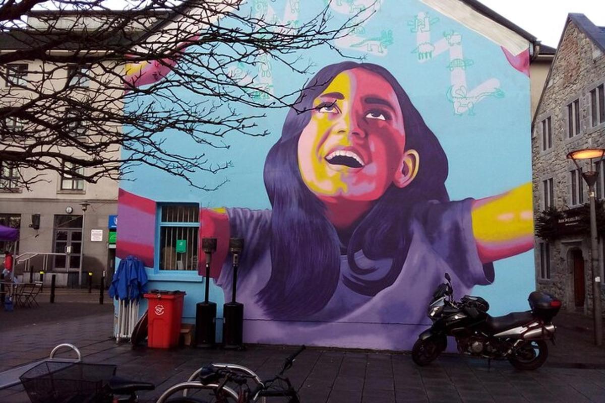 a large painting of a woman on the side of a building