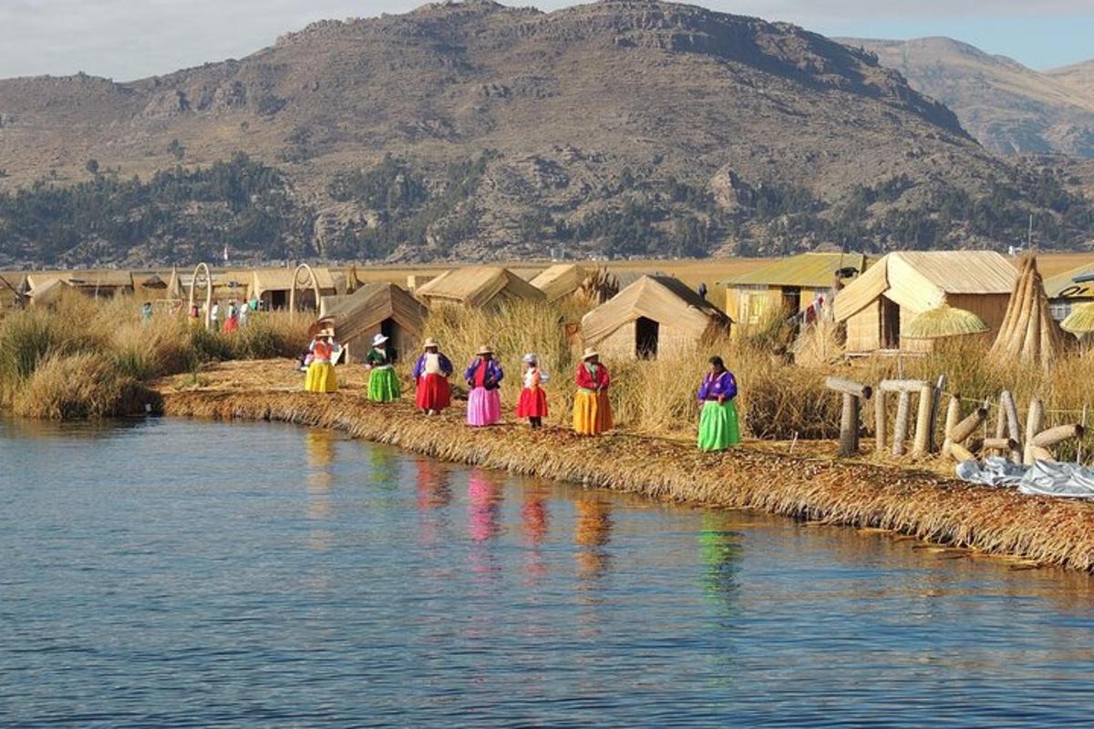 a group of people standing on the edge of a river