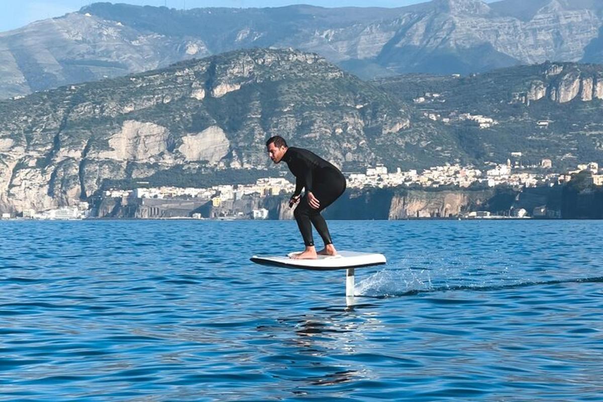 a man standing on a surfboard in the water