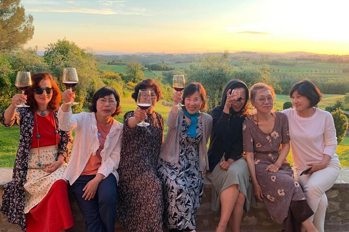 a group of women posing for a picture with wine glasses
