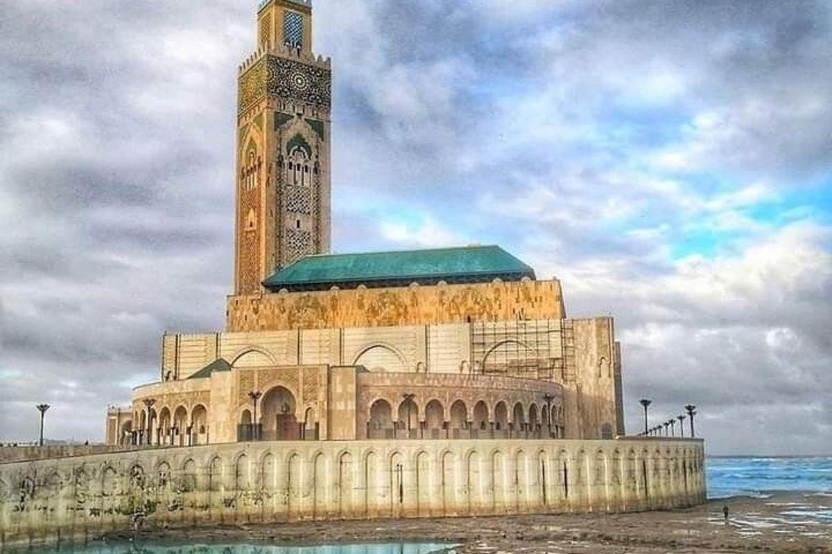 a large building with a clock tower on the water