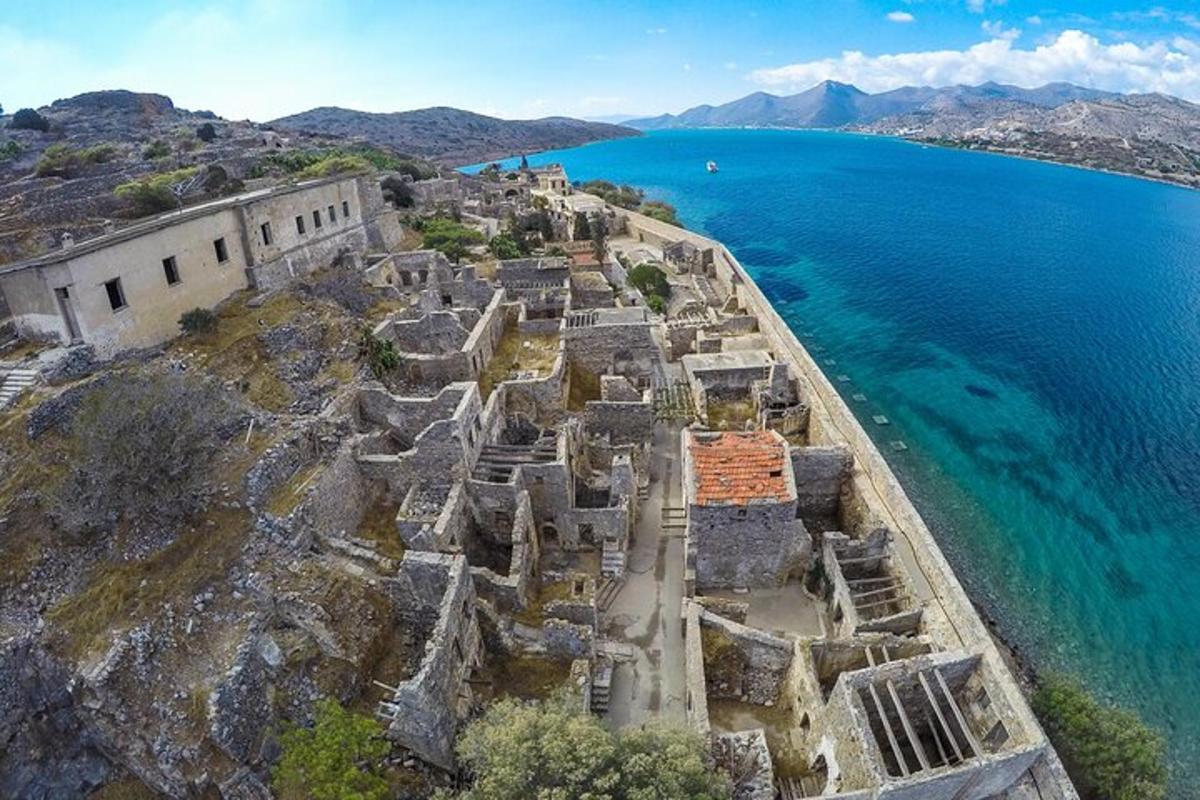 an aerial view of a fortress on a cliff next to the ocean