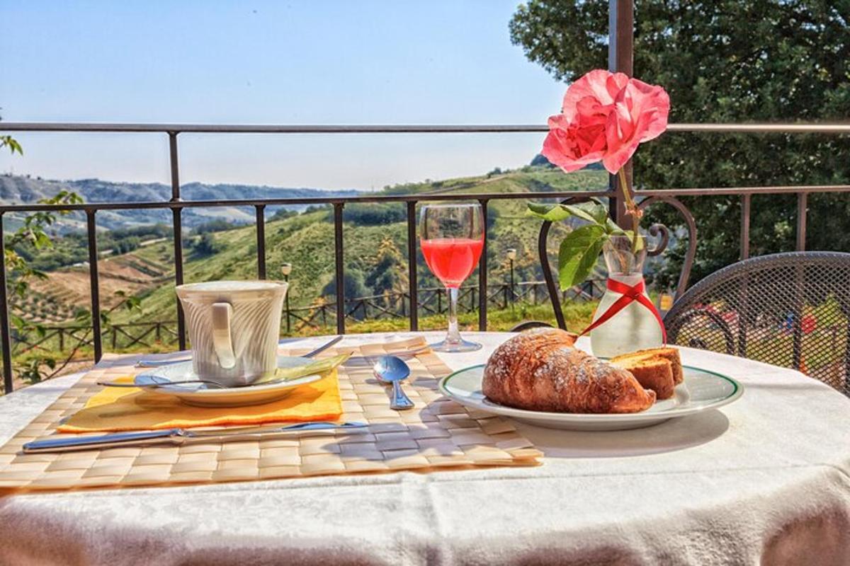 a table with a plate of food and a glass of wine