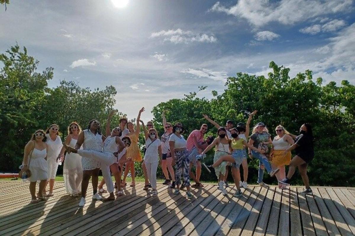 a group of people posing for a picture on a boardwalk