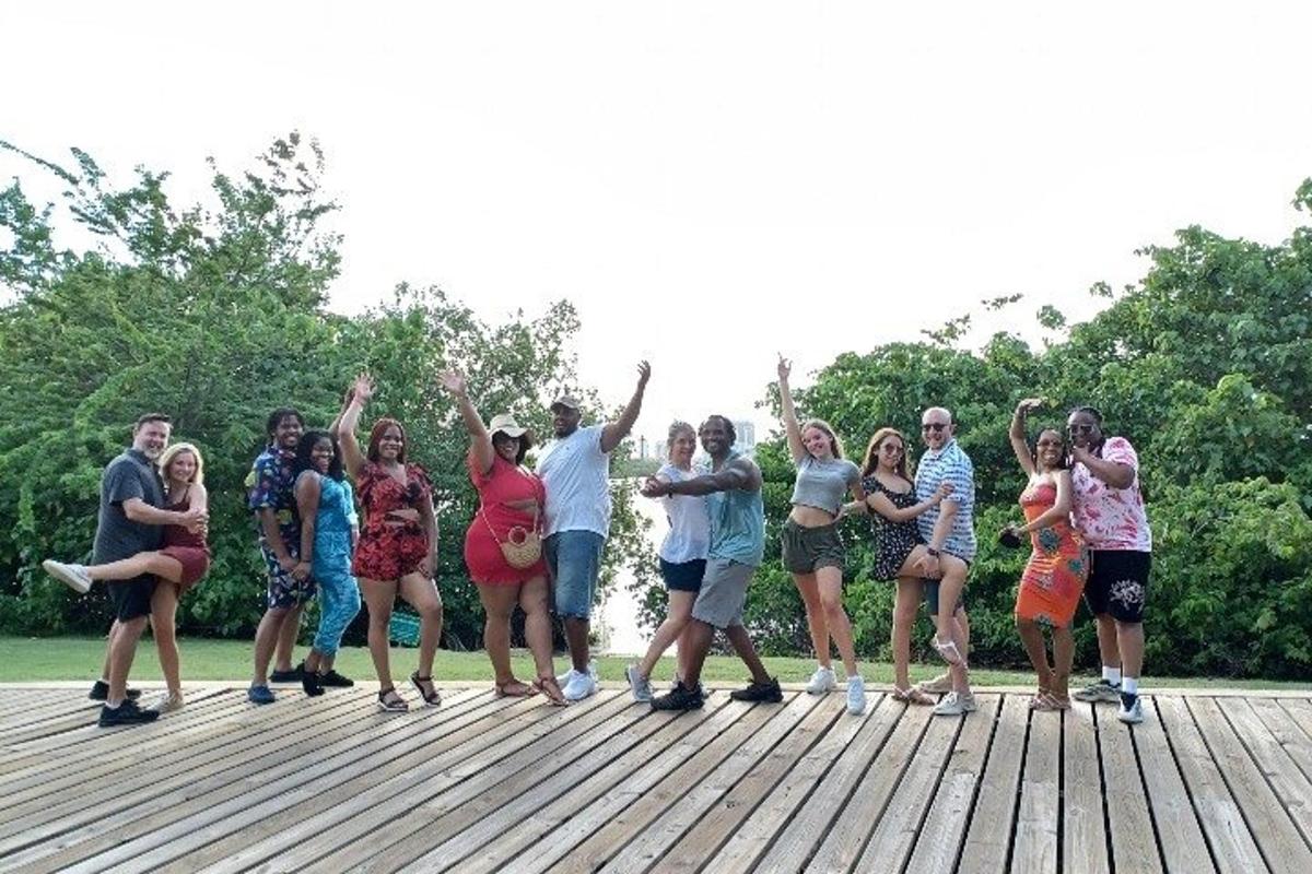 a group of people standing on a wooden deck