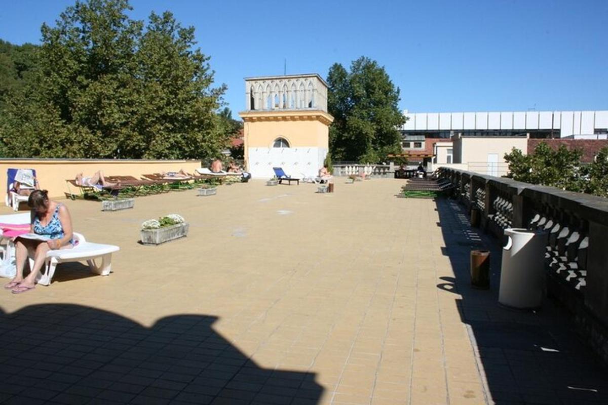 a woman sitting on a bench in a park