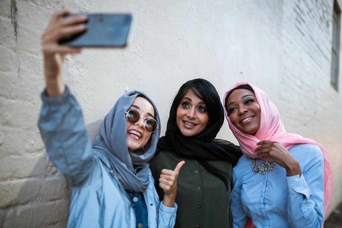 a group of three women taking a picture with a cell phone