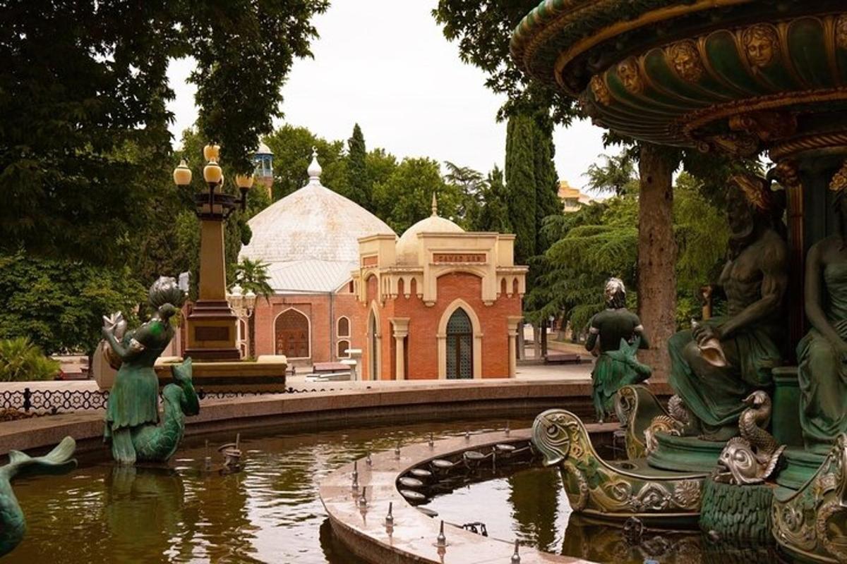 a fountain with statues in front of a building