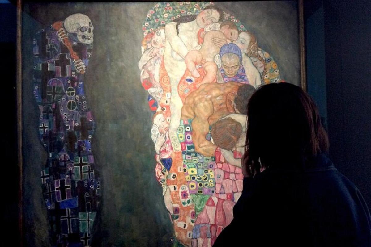a woman standing in front of a painting