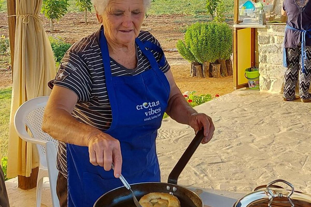 una donna che cucina il cibo in una padella su una griglia