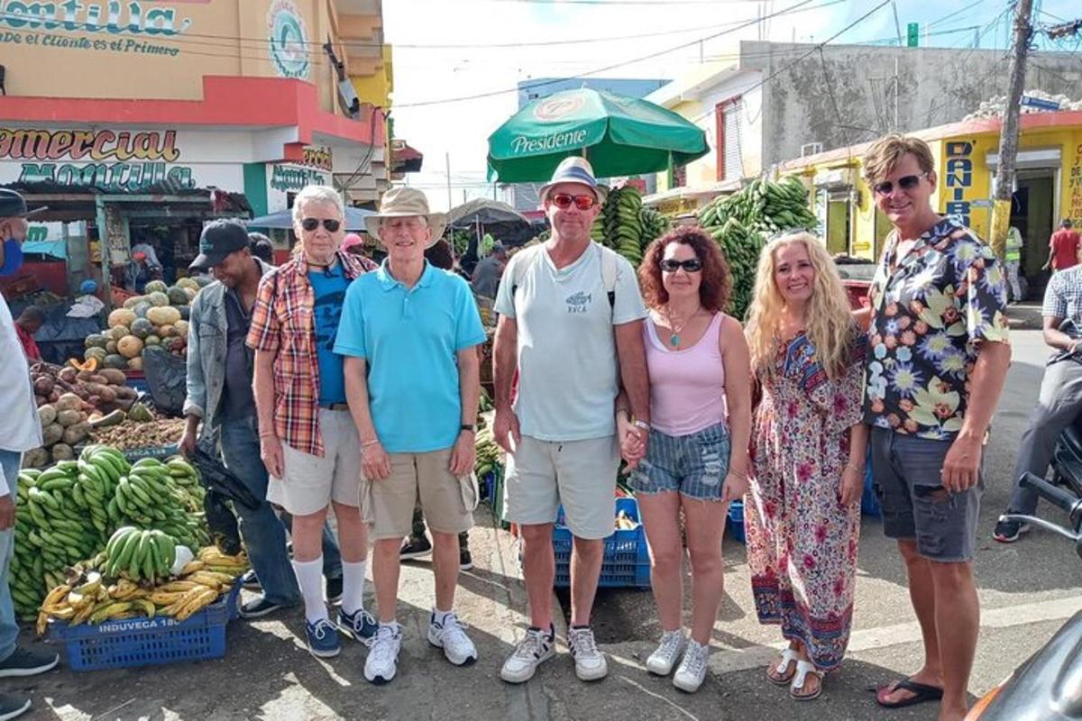 a group of people posing for a picture at a market