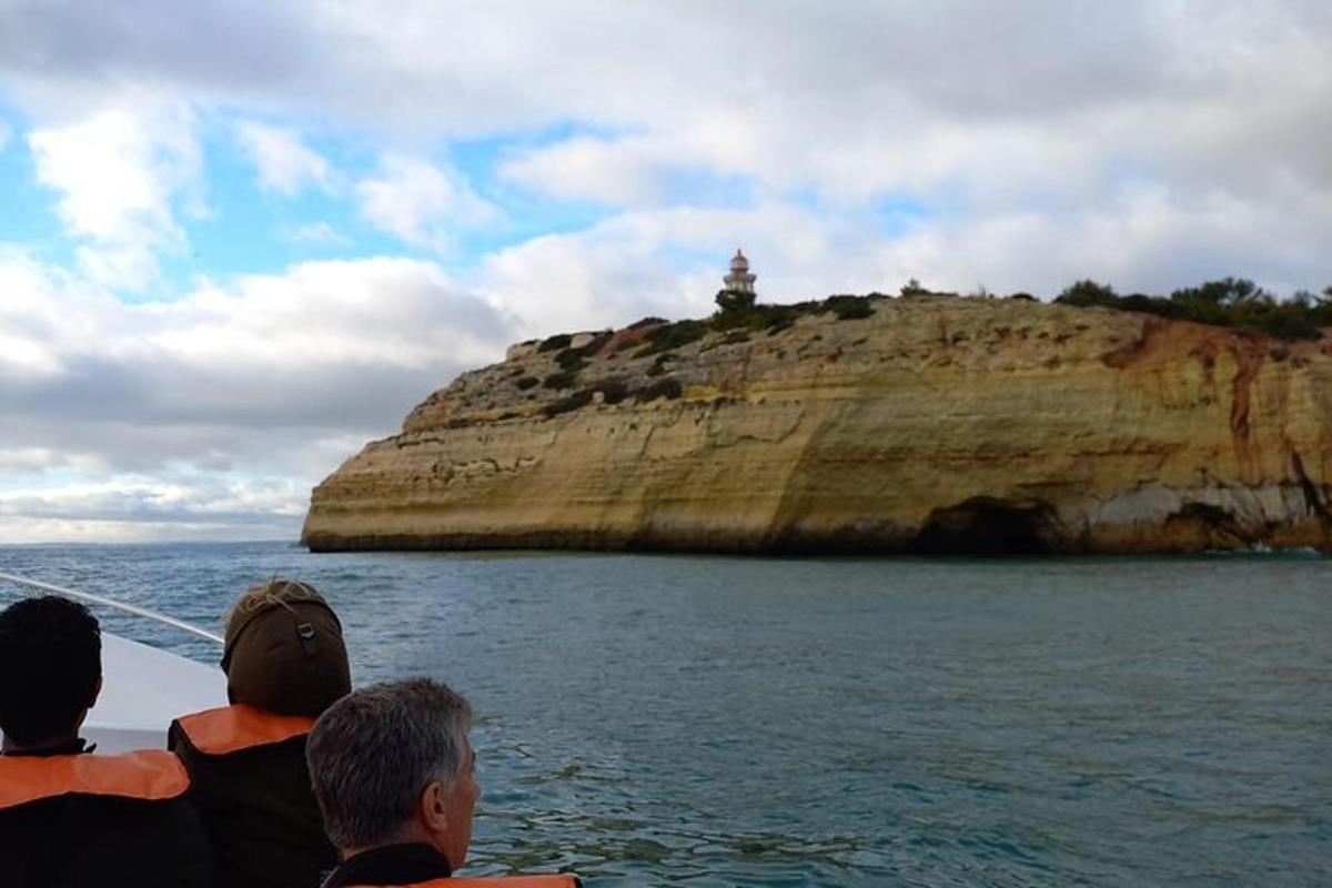 a group of people on a boat looking at an island