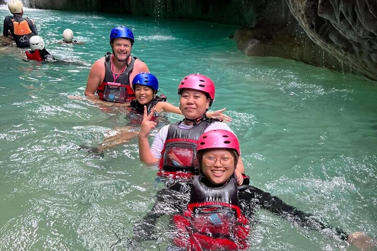 a group of people in the water wearing helmets