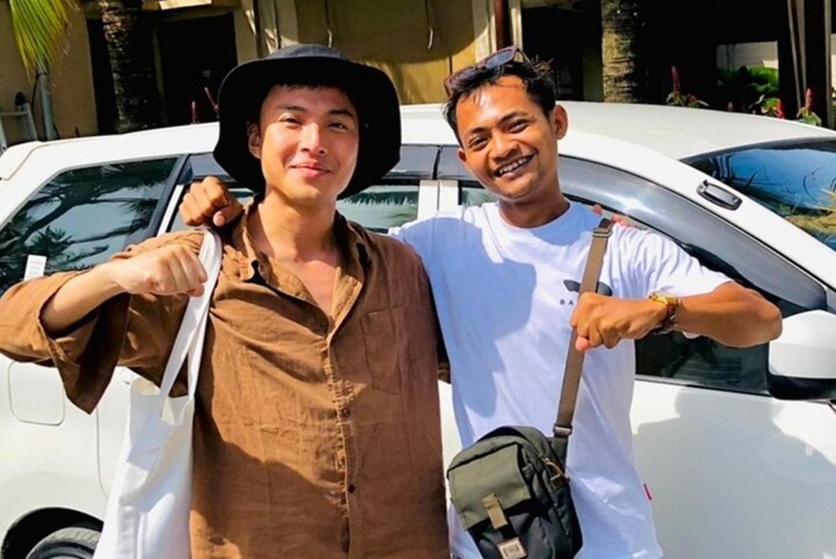 um homem e uma mulher parados na frente de um carro