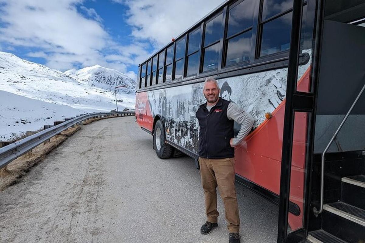 a man is standing next to a bus