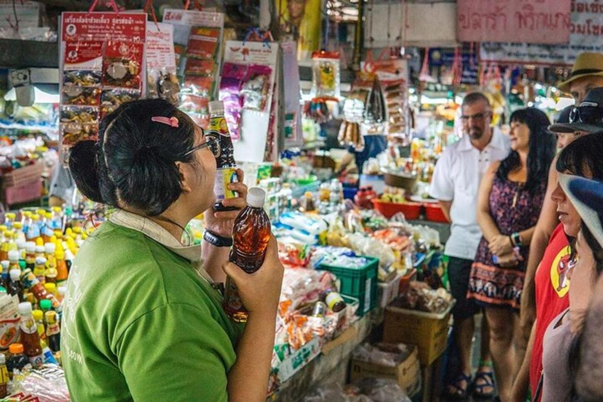 a woman standing in a market taking a picture