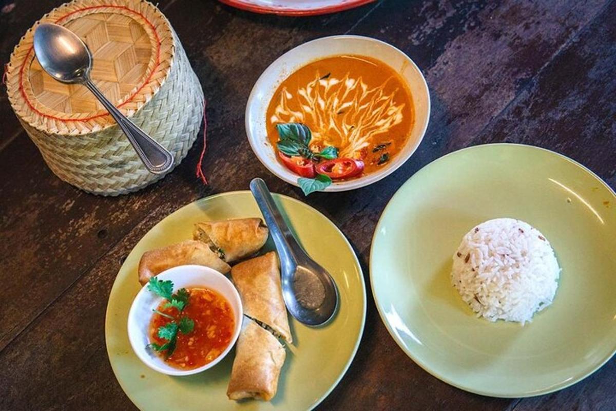 a table with plates of food and a bowl of soup