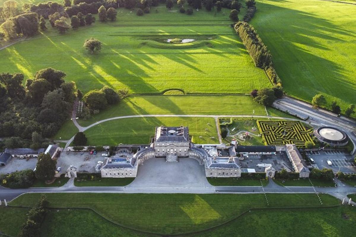 an aerial view of a mansion with a green field