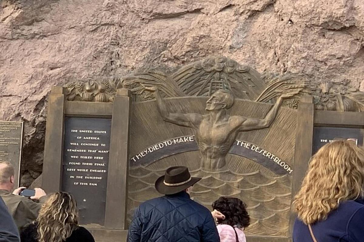 a group of people standing in front of a statue