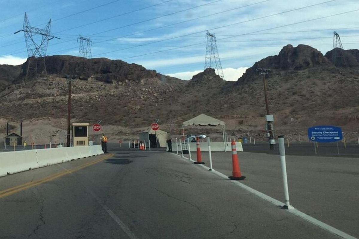 an empty road with mountains in the background