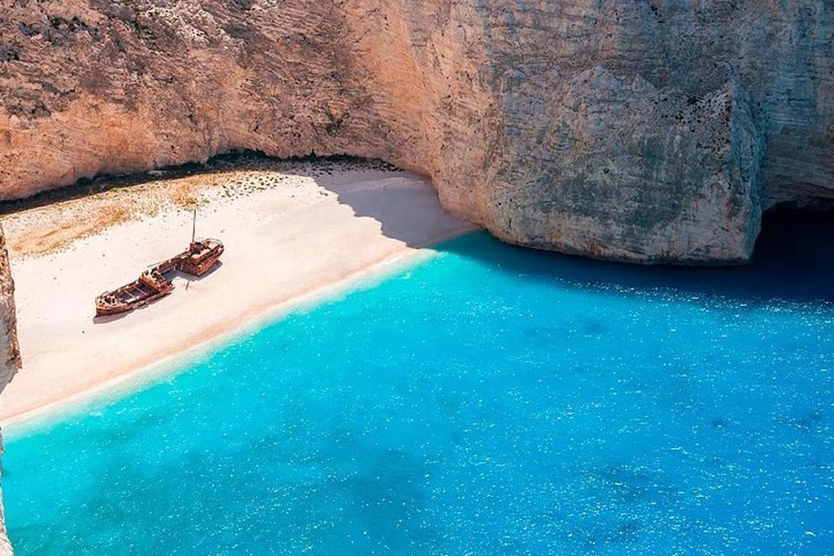 an aerial view of a beach with a hammock and the water