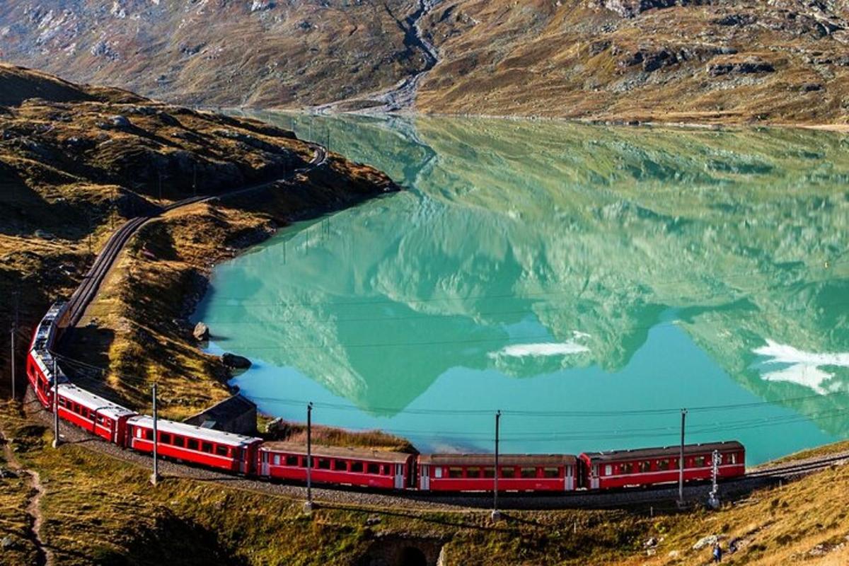 un treno sui binari accanto a uno specchio d'acqua
