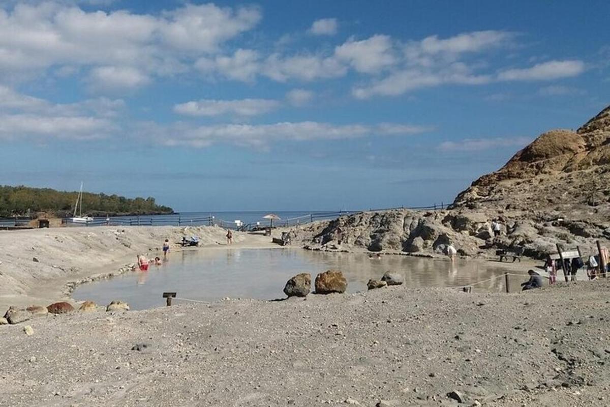 a beach with a group of people in the water