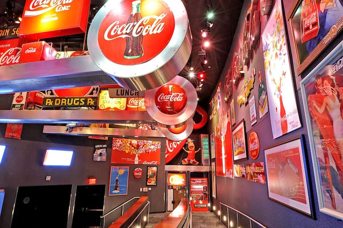 a room with many cocacola signs on the walls