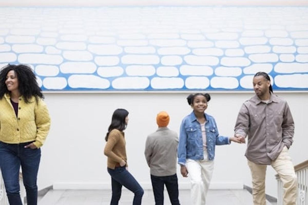 a group of people standing in front of a wall