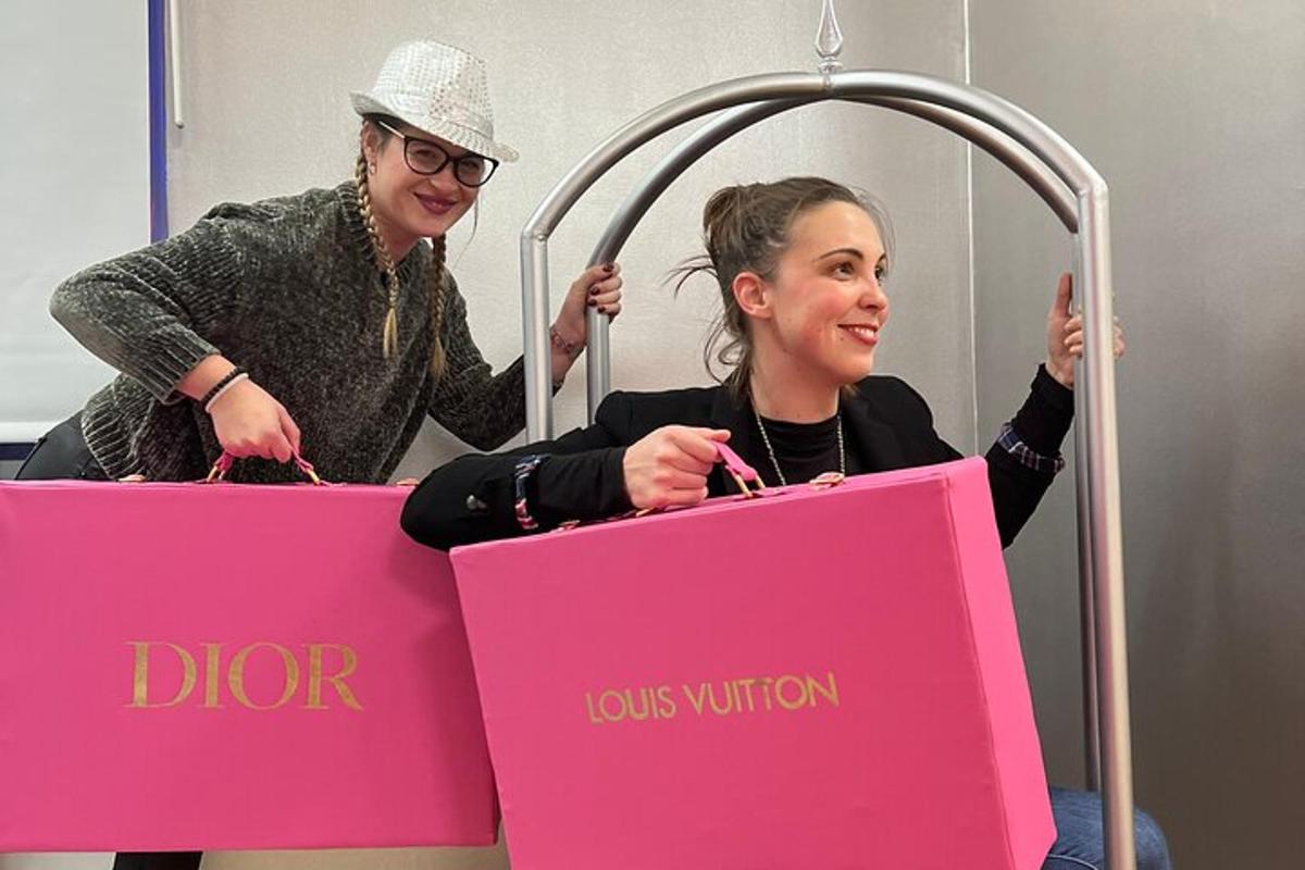 two women are holding pink shopping bags