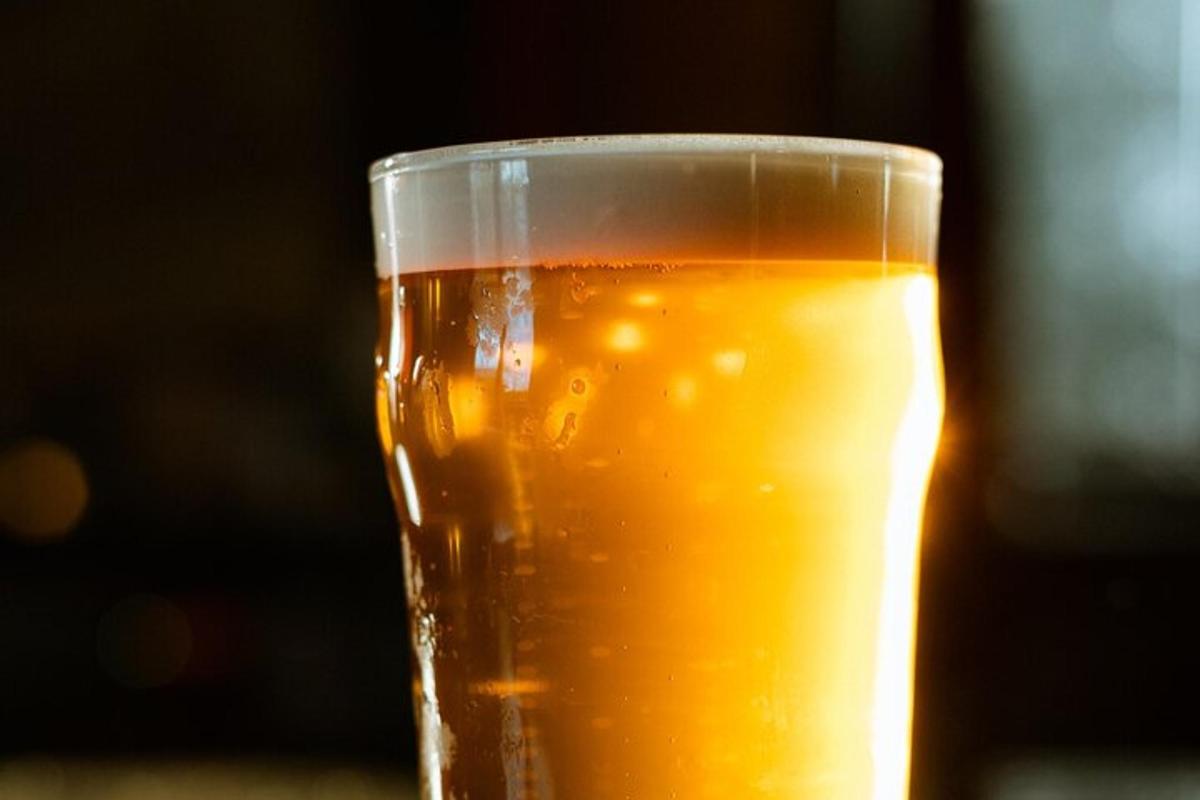 a glass of beer sitting on a table