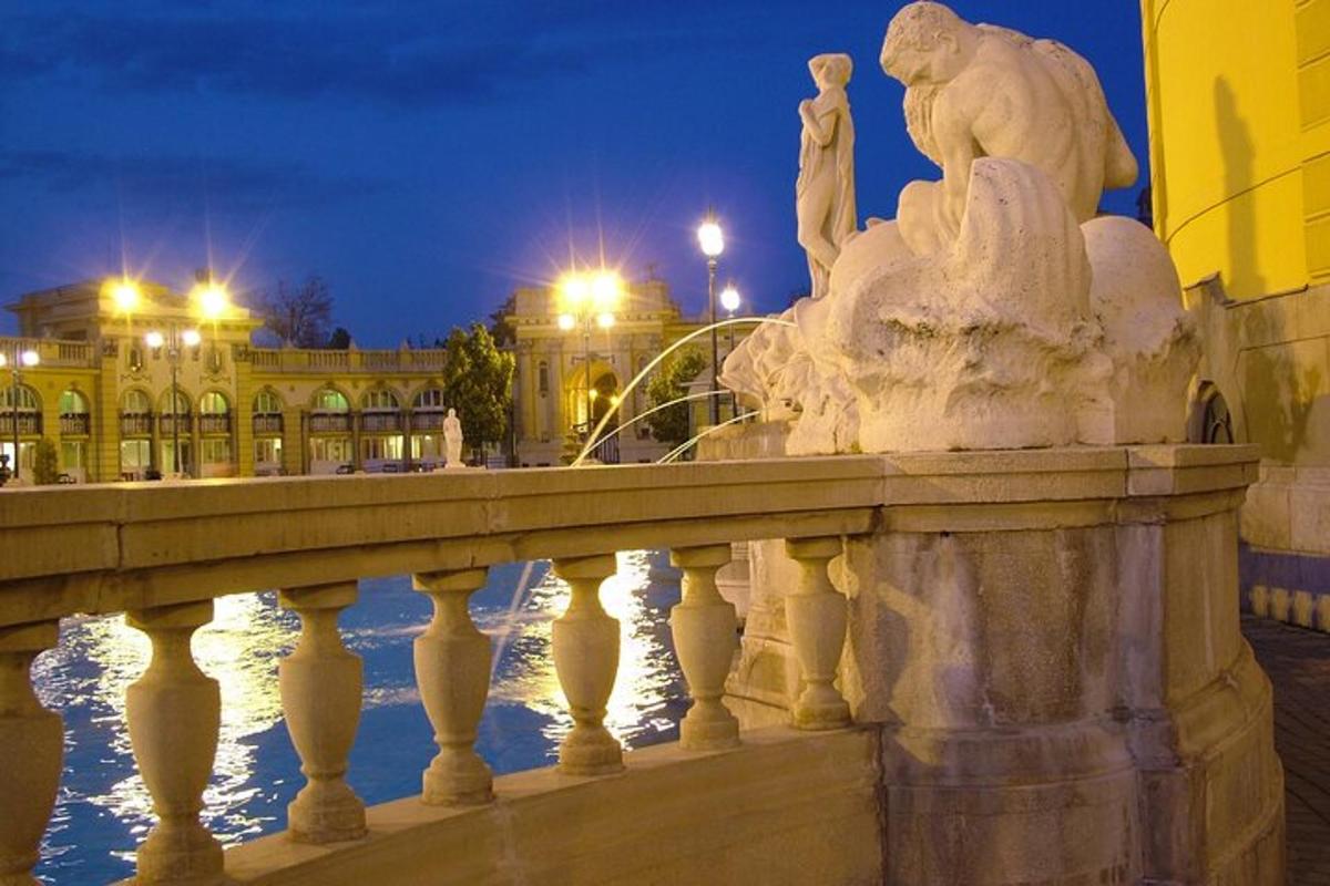 a statue on a bridge in front of a building