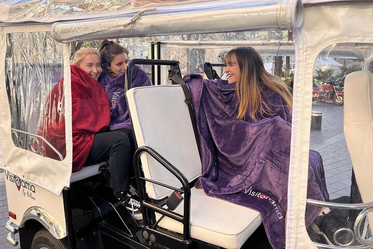 three girls are riding on a golf cart
