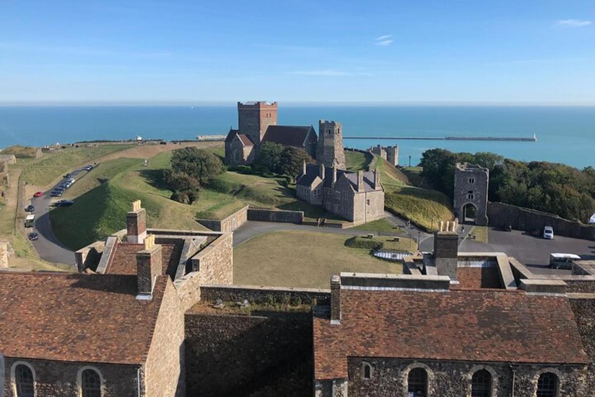 an aerial view of a castle with the ocean in the background
