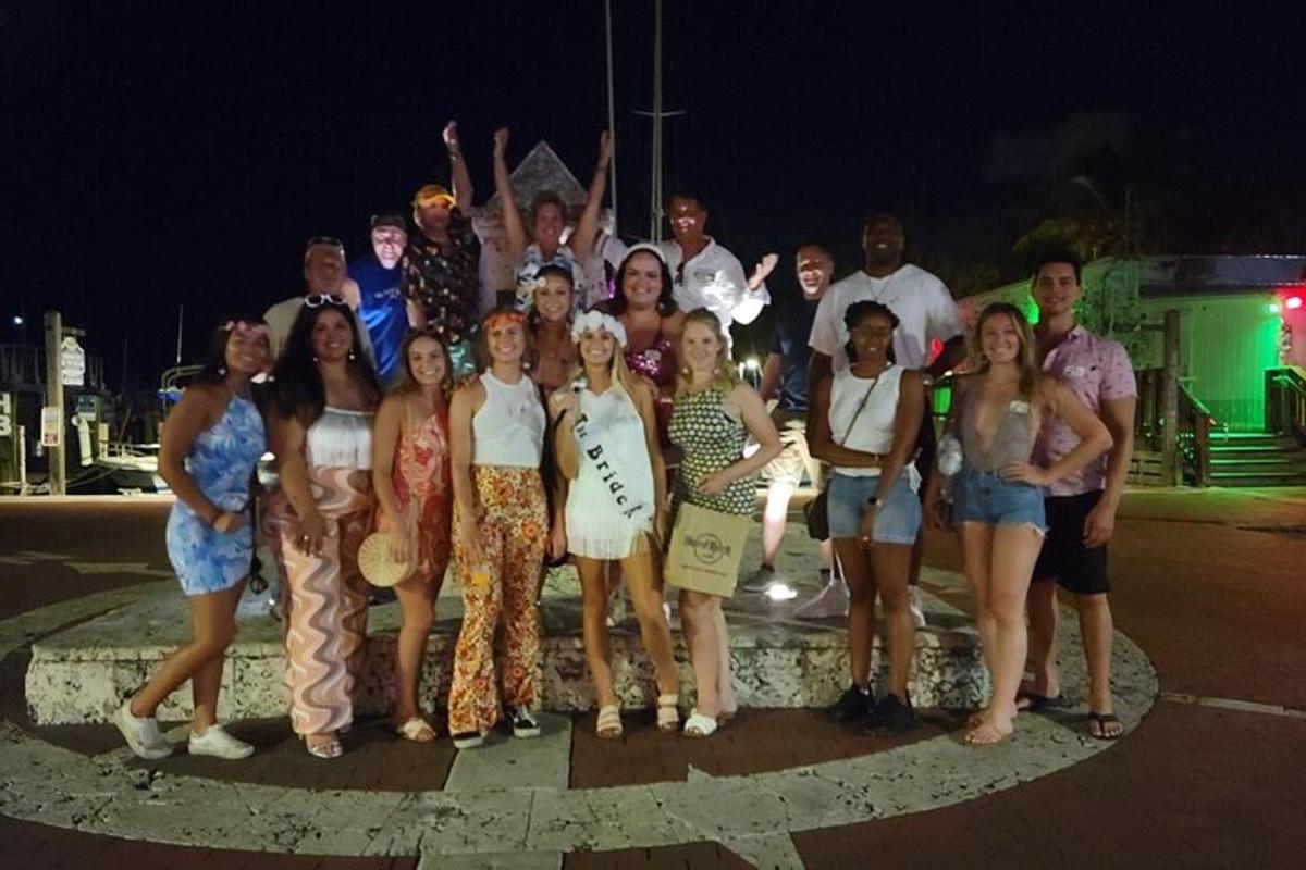 a group of people posing for a picture at night