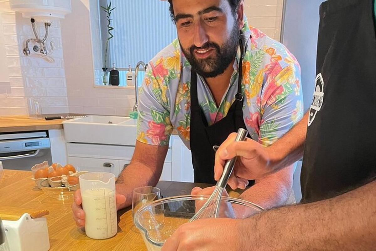 a man in a colorful shirt making a glass