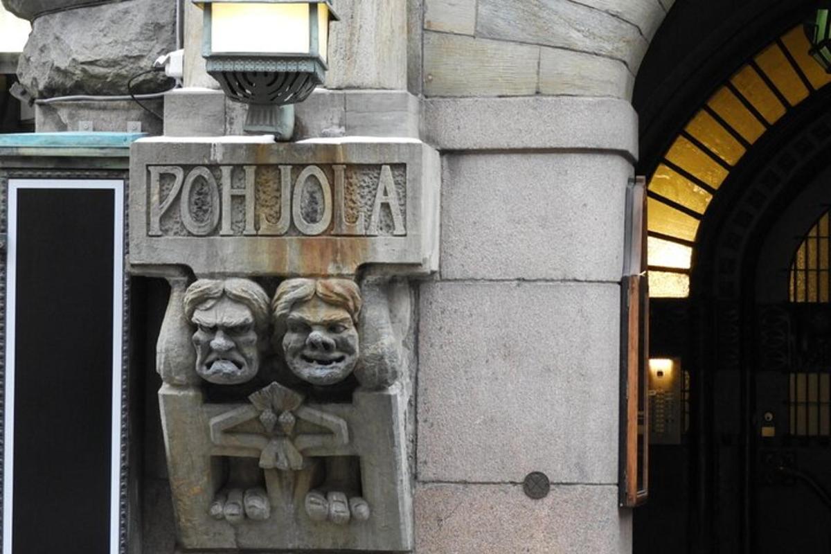 a sign on the side of a building with two masks